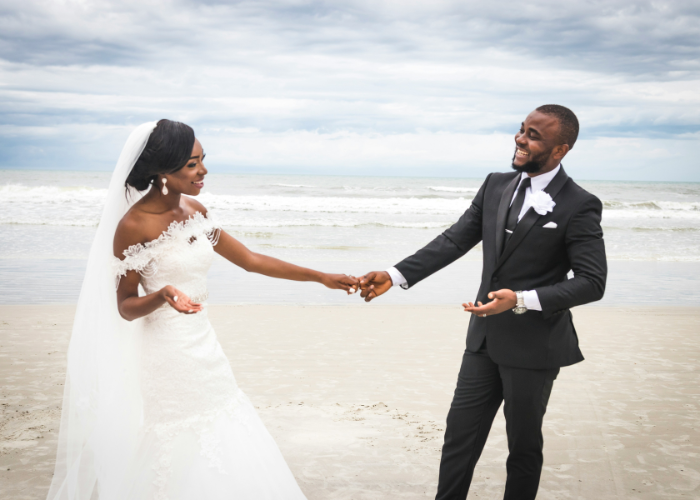 African American couple getting married at the beach.